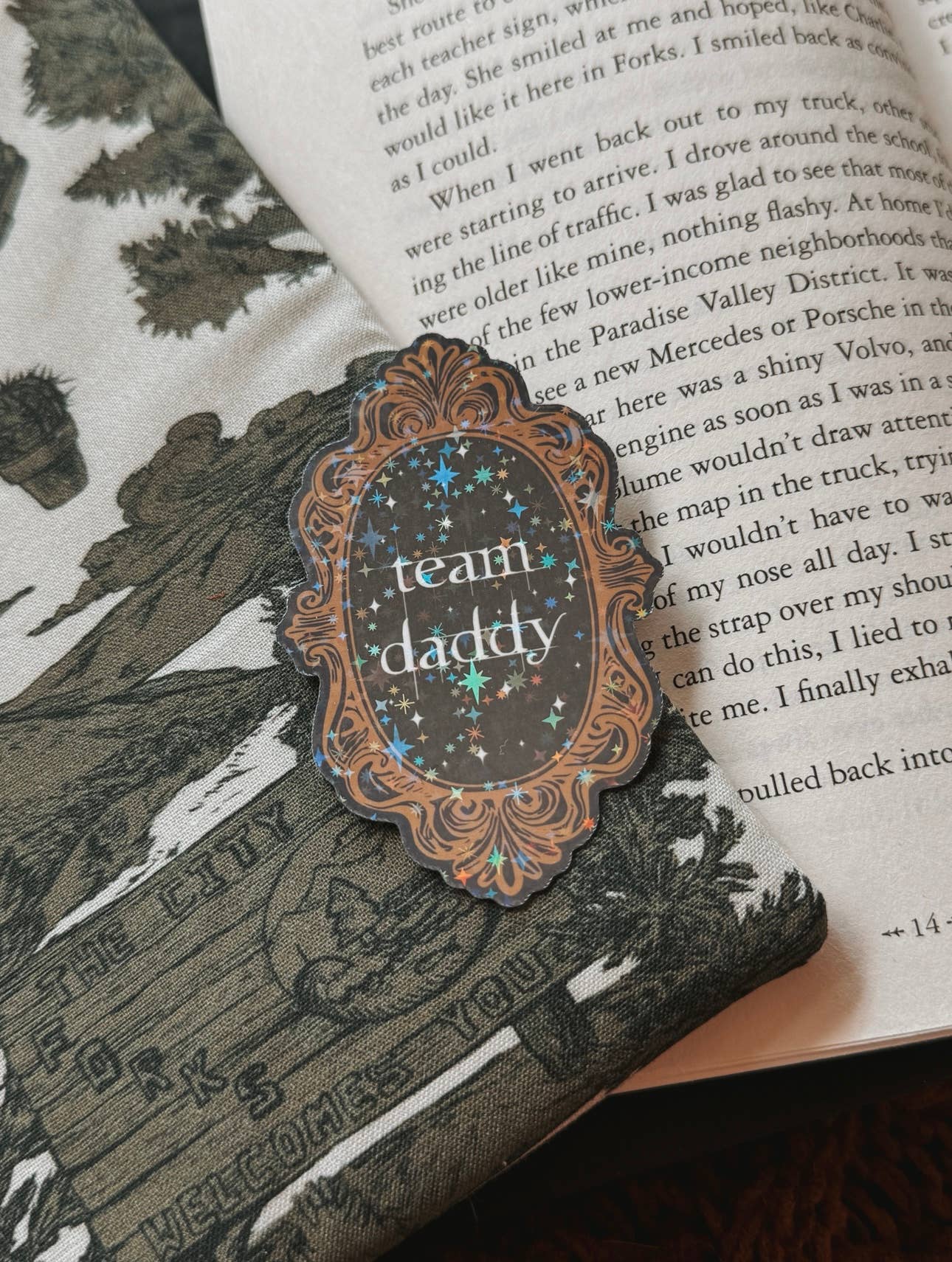 Decorative bookmark with 'team daddy' text on a book page.