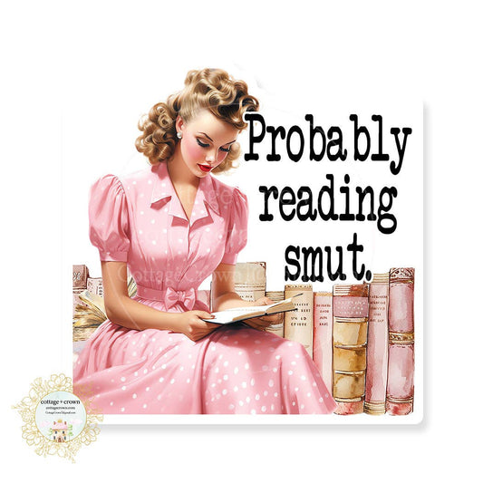 Vintage-style illustration of a woman in a pink dress reading a book with text 'Probably reading smut' on a white background.